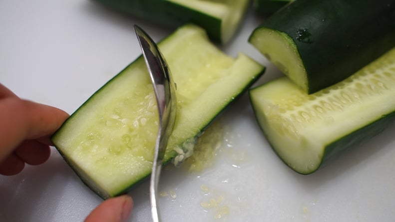 scooping out cucumber for cucumber shrimp sushi boats recipe from tiktok