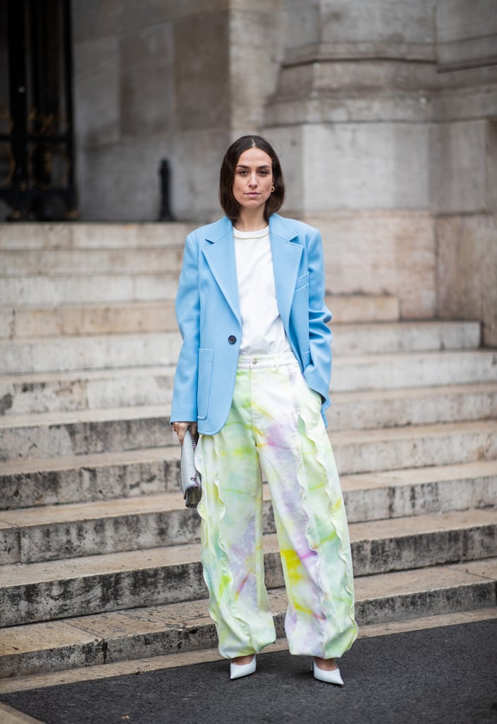 A white tee give this bright blazer and printed pants outfit a low-key feel.