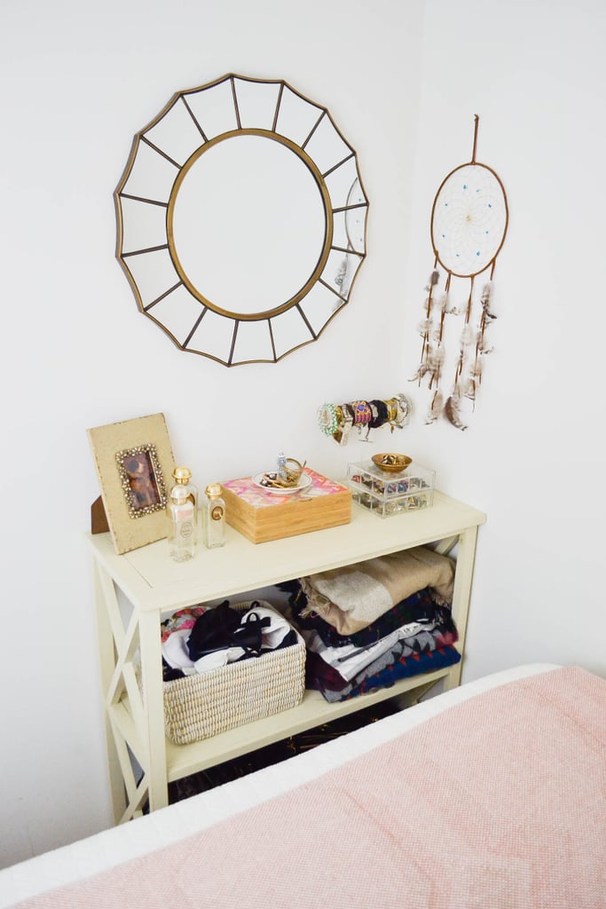 My trick for a makeshift bedside table? Try a console table at the foot of your bed. Chances are there's not much room to move around there anyway, so why not fill it with furniture to store your belongings instead.