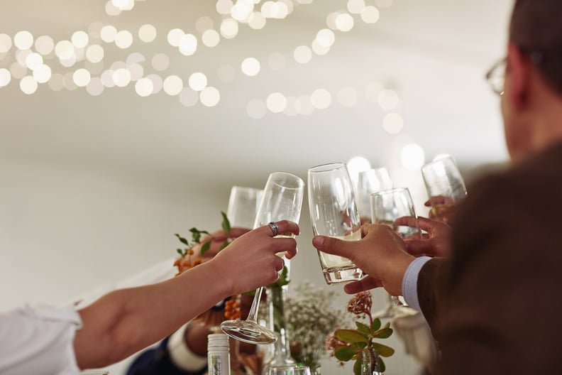 Group of Wedding Guests Toasting With Wine at a Wedding Reception