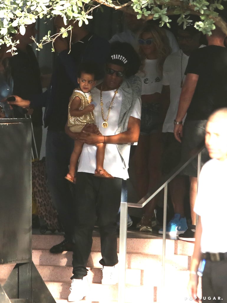 Jay Z carried Blue Ivy down the stairs while Beyoncé followed close behind.
