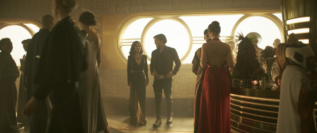 Han and Qi'ra share an intimate moment in a crowded party.