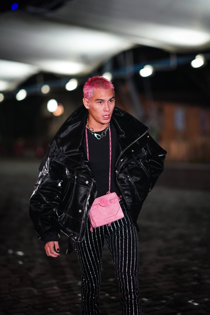 Matching his pink hair with a Balmain handbag.