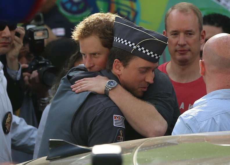 Harry hugged a policeman while visiting the Open Arms project in São Paulo in 2014.