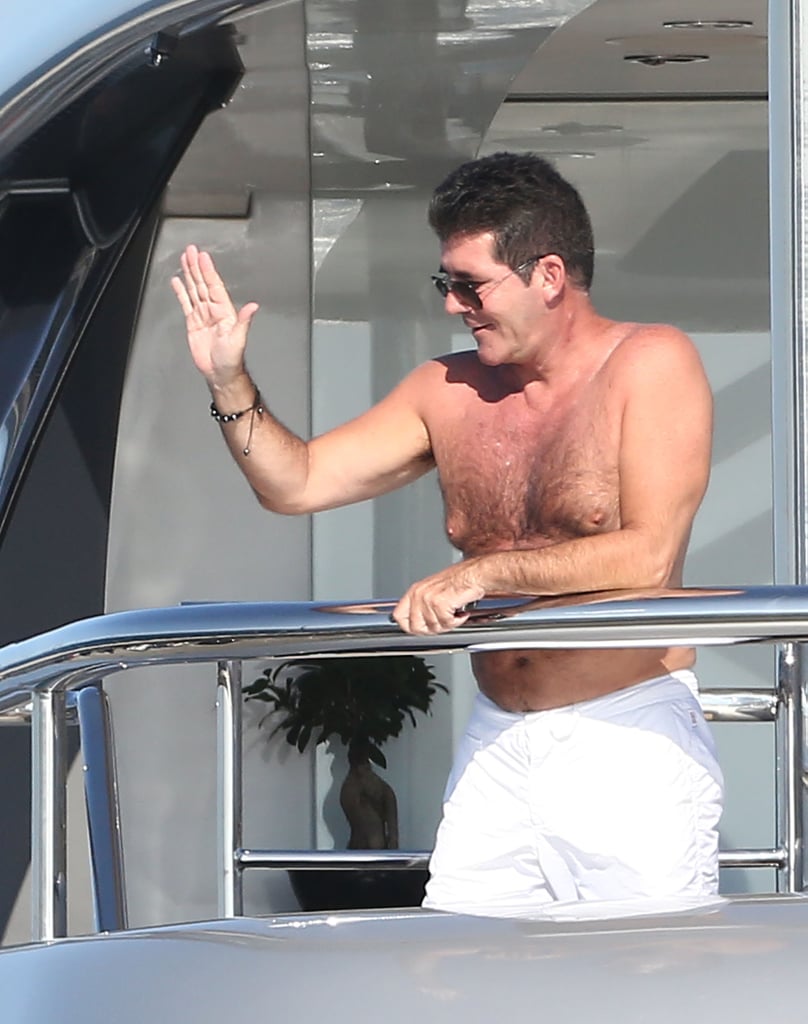 Simon Cowell greeted someone from his yacht in France in August 2012.