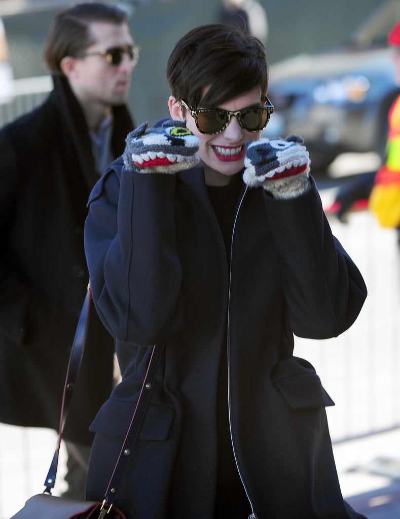 Anne Hathaway had fun with her puppy mittens on Monday at Sundance.