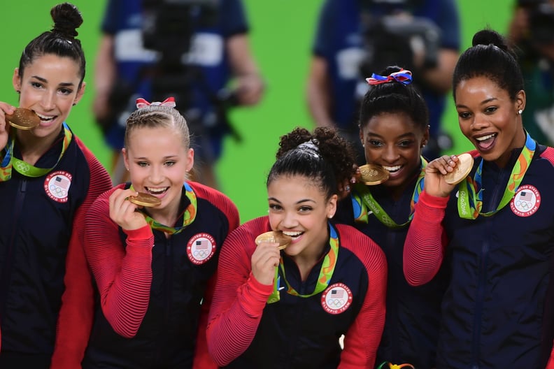 US gymnasts Alexandra Raisman, Madison Kocian, Lauren Hernandez, Simone Biles and Gabrielle Douglas celebrate with their gold medals on the podium during the women's team final Artistic Gymnastics at the Olympic Arena during the Rio 2016 Olympic Games in 