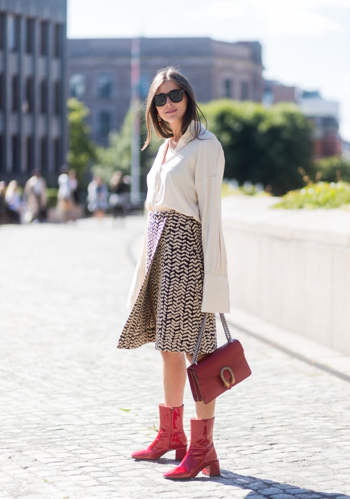 Tuck a long-sleeved button-down into your wrap skirt, and think bright when it comes to your bag and boots.