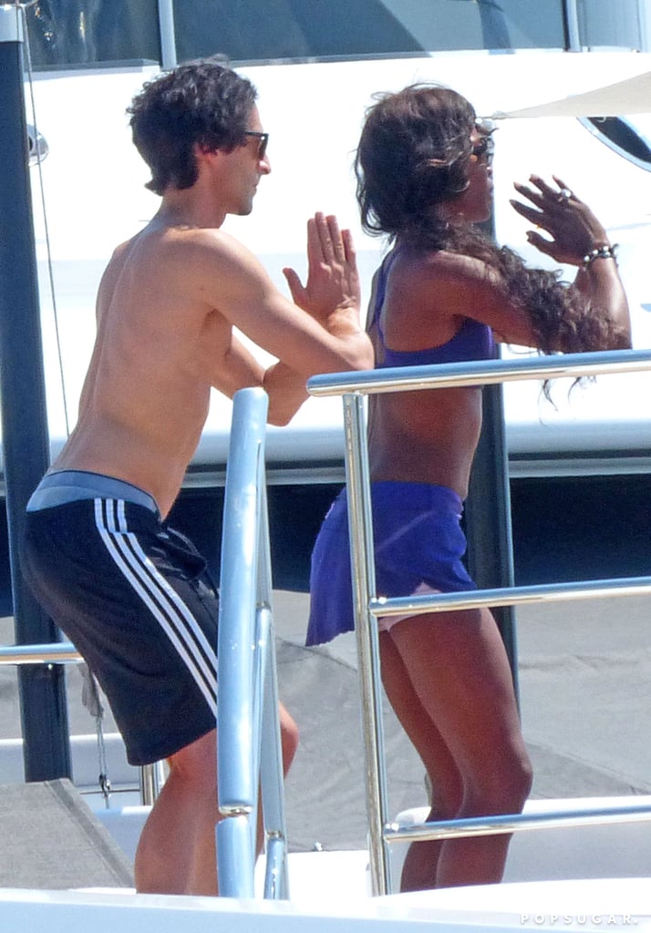 Naomi Campbell and Adrien Brody did yoga on a boat while vacationing off the coast of Ibiza in August 2013.