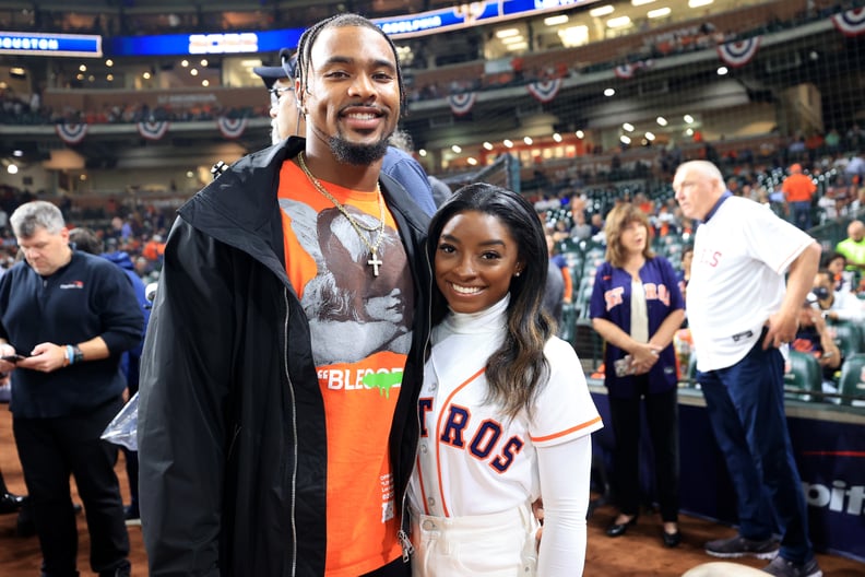HOUSTON, TEXAS - OCTOBER 28:  Simone Biles and Jonathan Owens pose on the field prior to Game One of the 2022 World Series between the Philadelphia Phillies and the Houston Astros at Minute Maid Park on October 28, 2022 in Houston, Texas. (Photo by Carmen