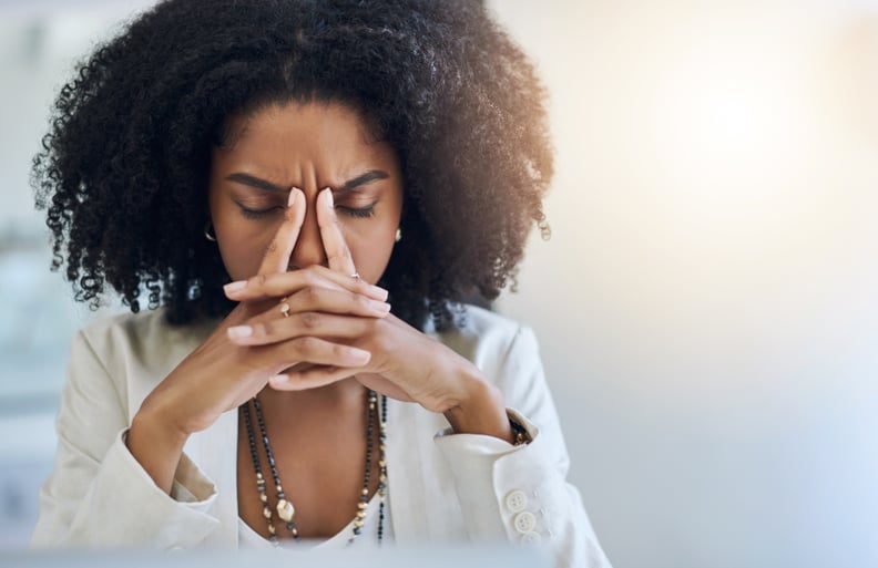 Shot of a young businesswoman looking stressed out in her office