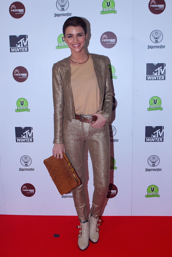 Wearing a glittering suit and neutral clutch to an MTV photocall in 2012.