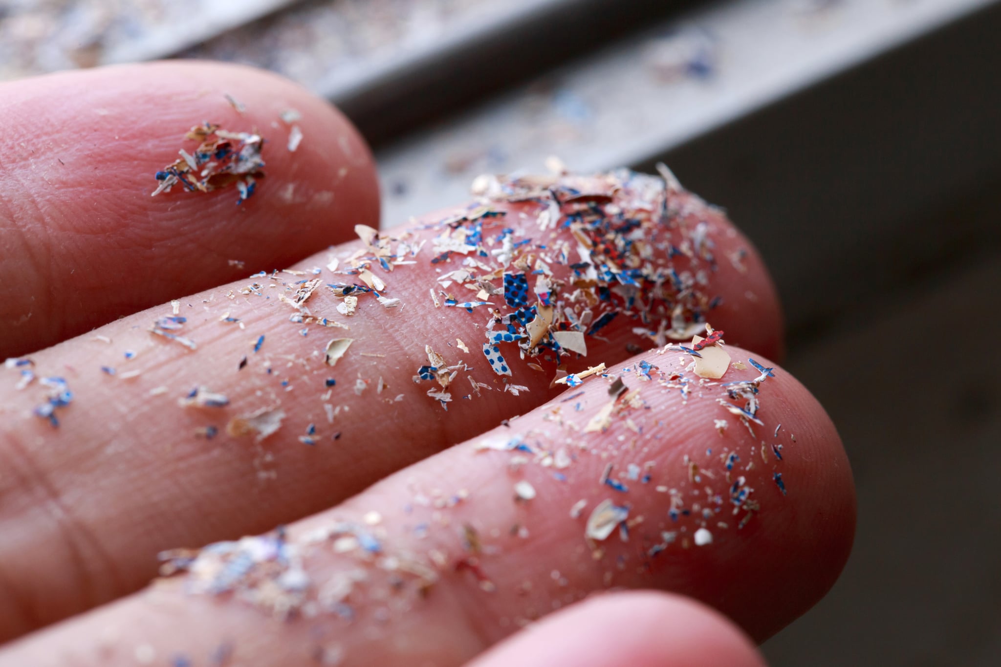 Close up side shot of microplastics lay on people hand.Concept of water pollution and global warming. Climate change idea.