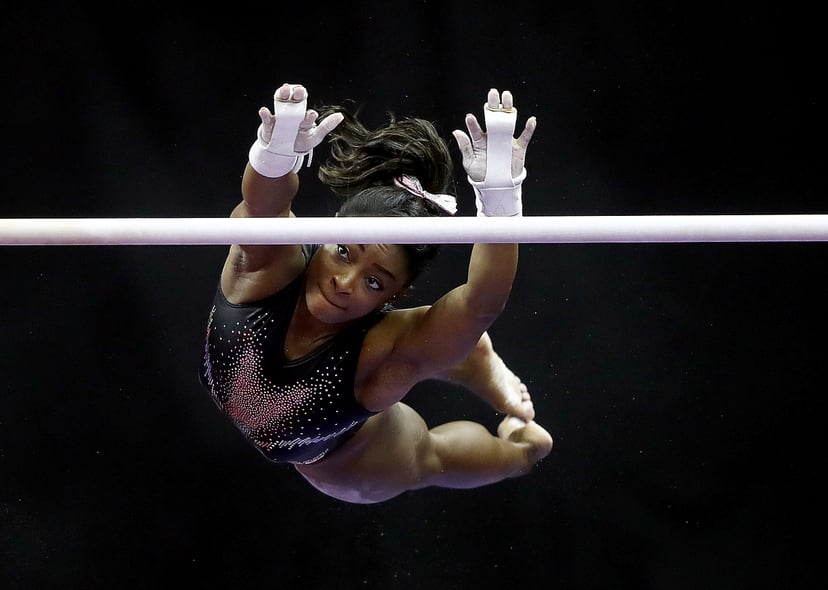KANSAS CITY, MISSOURI - AUGUST 11:  Simone Biles warms up on the uneven bars prior to the Women's Senior competition of the 2019 U.S. Gymnastics Championships at the Sprint Center on August 11, 2019 in Kansas City, Missouri. (Photo by Jamie Squire/Getty I