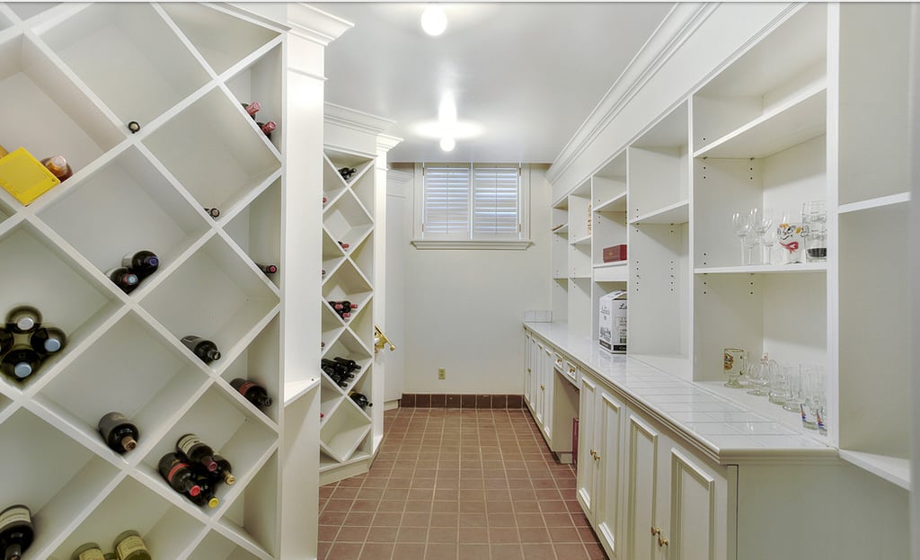 A private wine cellar and wet bar make the lower level the perfect place to throw a bash.