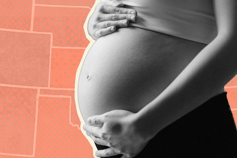 A photo of a pregnant woman holding her belly.