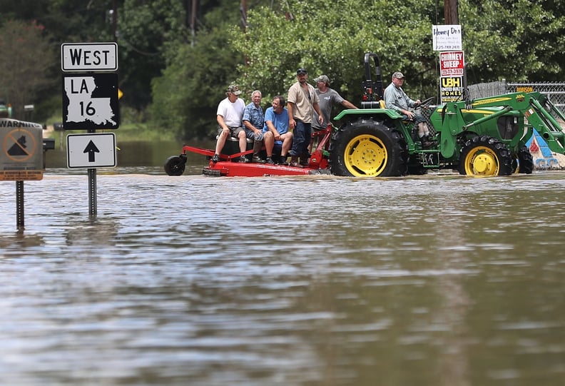 People are rescued by a tractor in Port Vincent, LA.