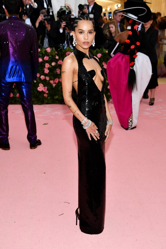 Zoë Kravitz could major in sexy Met Gala dresses, with her flawless track record. The Big Little Lies actress arrived at The Metropolitan Museum of Art in NYC on May 6, all dressed up in a sultry, eye-catching Saint Laurent number. 
The all-black sequined gown might appear demure from the back, but the front is all about the skin-baring cutouts. Zoë tied the look together with dangling statement pearl earrings and layered silver bracelets, letting the dress do most of the talking. While her look was definitely subtler than some of the other "Camp: Notes on Fashion"-themed looks we've seen, it certainly added some heat to the red carpet. Keep reading to see more angles of Zoë's daring choice ahead.