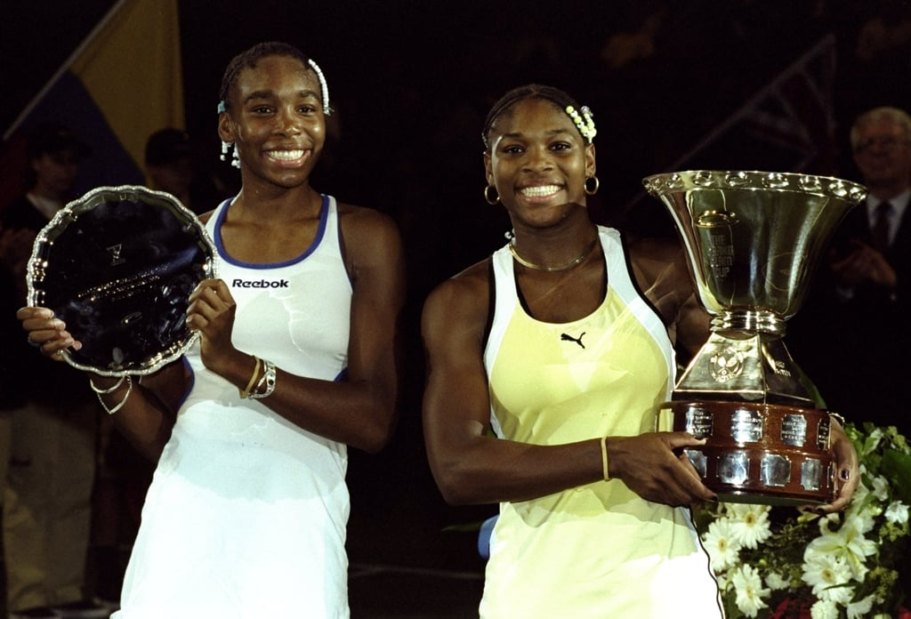 Venus and Serena Williams With Their Trophies at the Grand Slam Cup in 1999