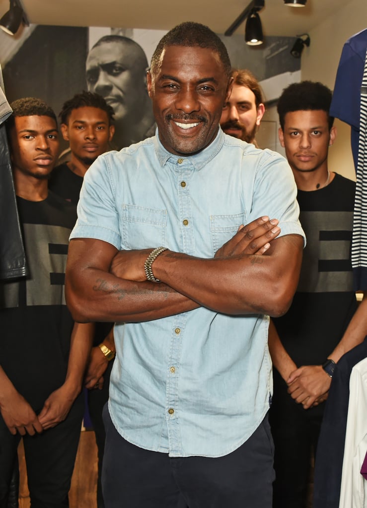 If it wasn't already glaringly obvious that Idris Elba should be your biggest celebrity crush, then prepare yourself for a learning experience. The Luther actor celebrated the launch of his clothing collaboration with Superdry at an event in London on Sunday, where he wore a tight, short-sleeved denim button-down shirt and an expression that said, "I'm at least 11 times more charming than James Bond, and I know it." In addition to providing plenty of eye candy at the launch, the Star Trek villain also acted as DJ, spinning plenty of hits while casually flexing his muscles and offering a few arresting smiles for the crowd. In other words, it was just a typical day in the life of Idris Elba.