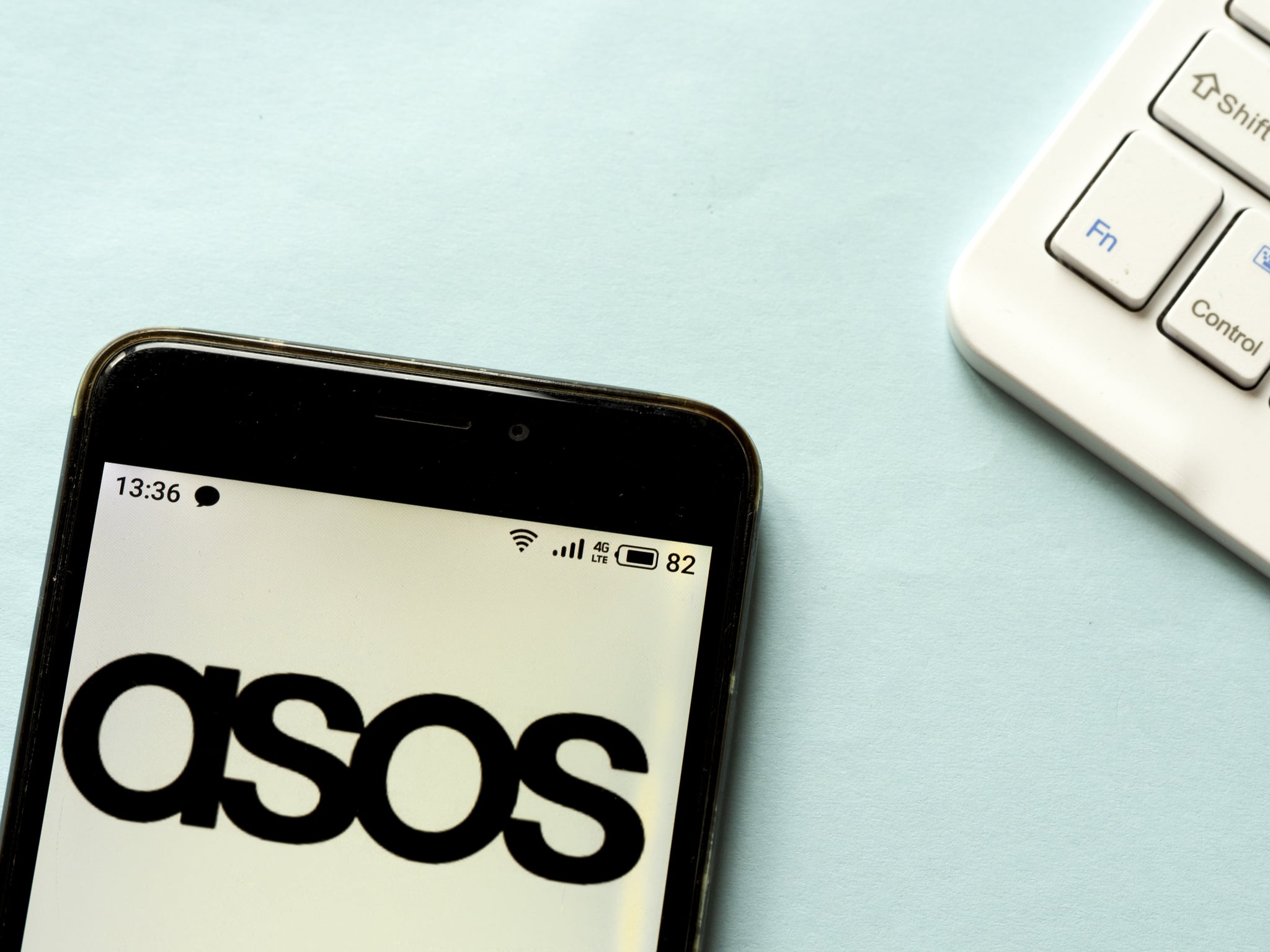 UKRAINE - 2020/04/25: In this photo illustration an Asos logo is seen displayed on a smartphone. (Photo Illustration by Igor Golovniov/SOPA Images/LightRocket via Getty Images)