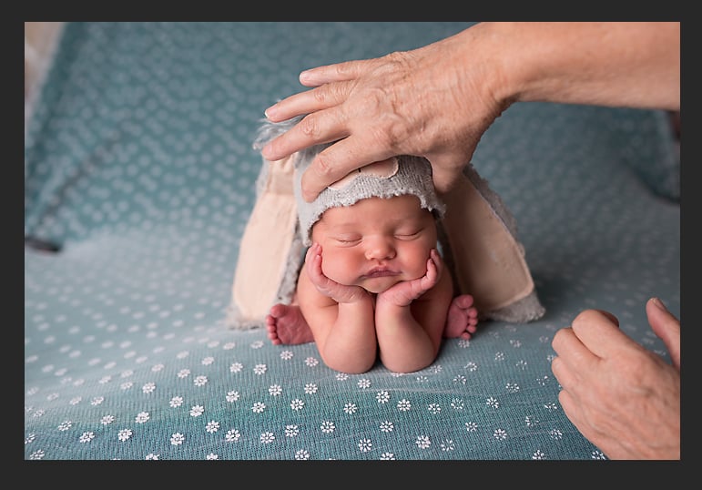 With the help of an assistant or parent, the second shot is taken when they "use their other hand to hold the baby's head, and slowly the hand holding the wrists is removed."
