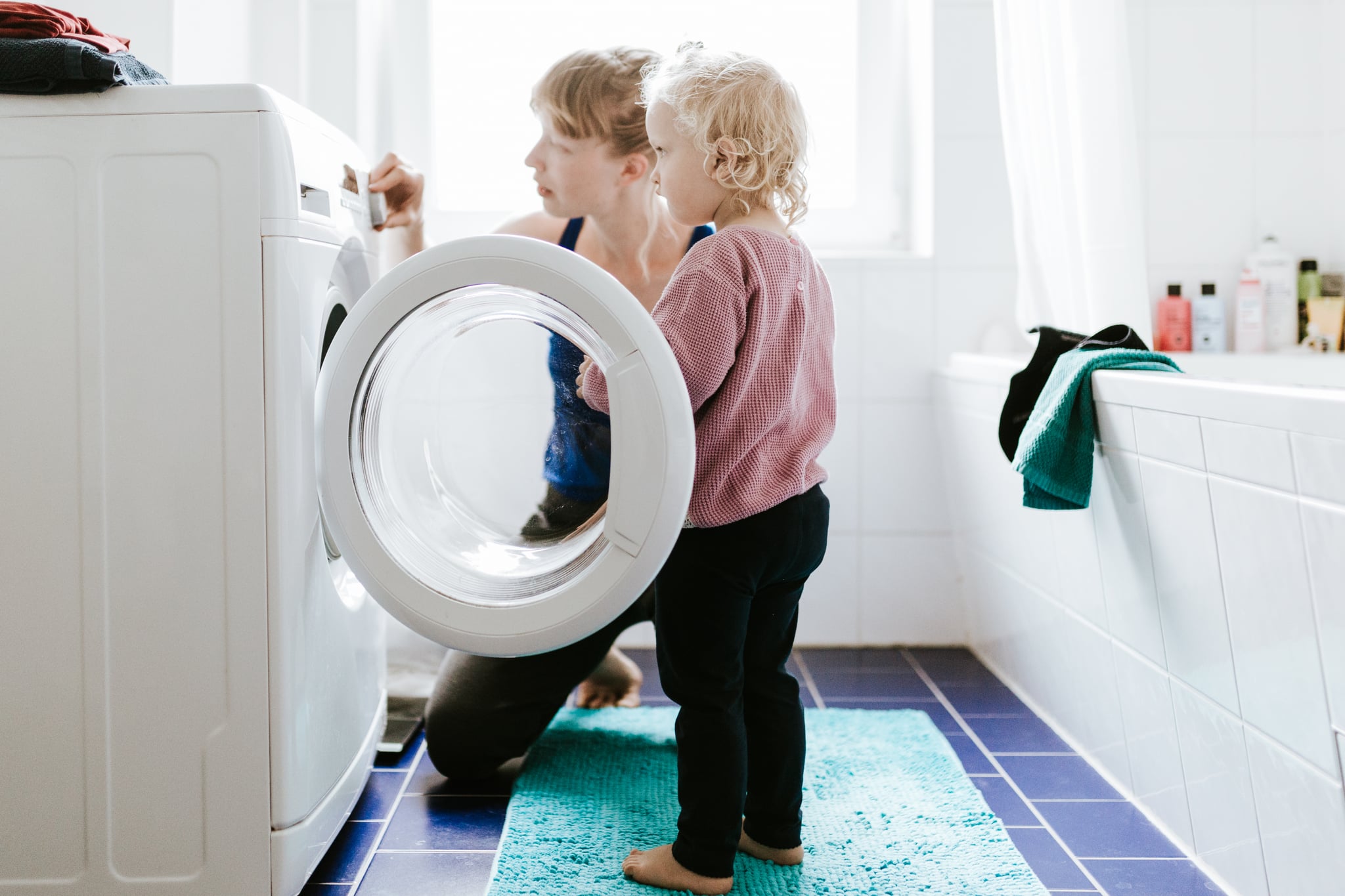 Photo series of a young mother with a child doing different chores at home. Shot in Berlin.