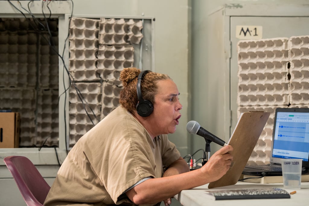 Cathy (Marcia DeBonis) reads out the morning announcements.