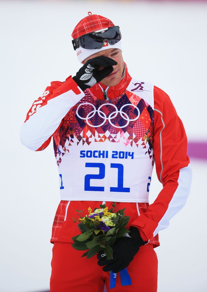 Gold medalist Dario Cologna of Switzerland teared up during the flower ceremony for the men's 30km skiathlon event.