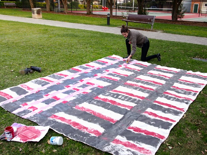 Then take your second "pop" color and run thin stripes alongside each of the top neutrals. Once you’ve completed these, just leave the drop sheet out to dry!