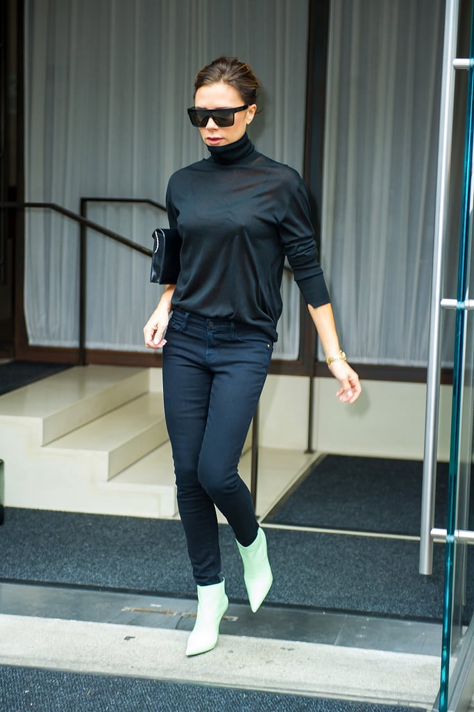 Victoria added a pop of colour to her dark outfit with pastel green ankle boots.