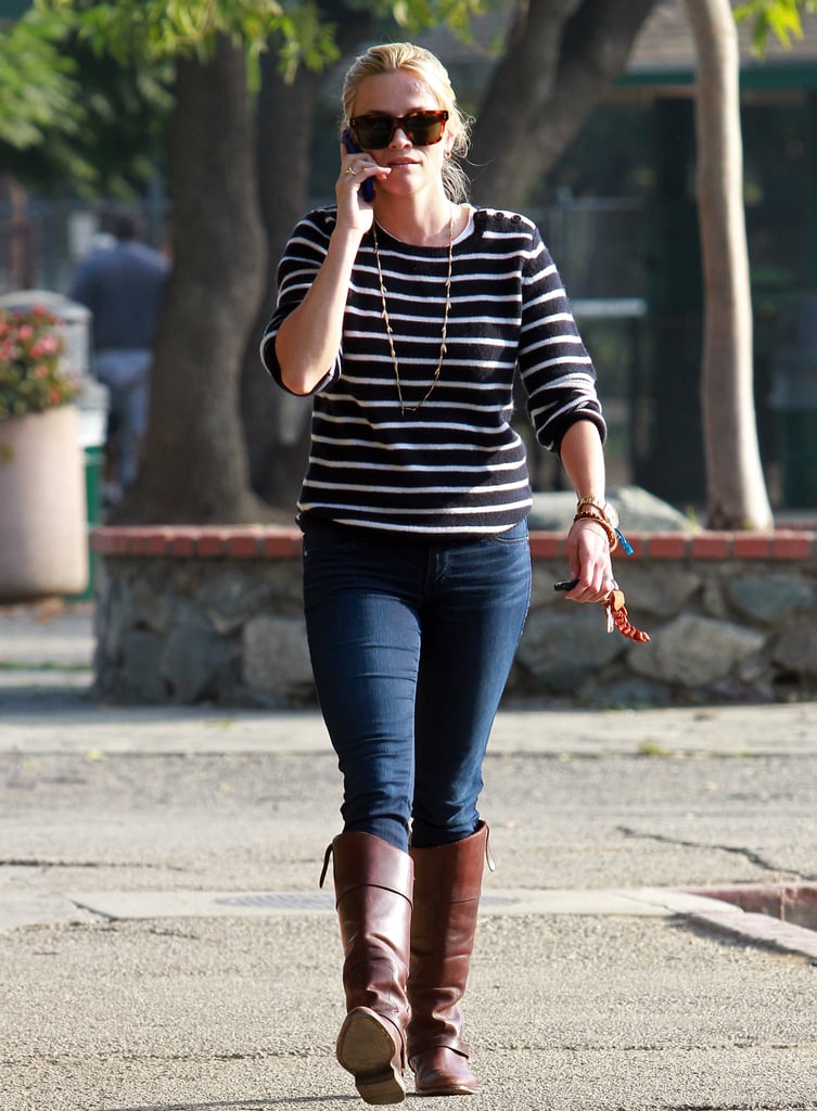 For a day of errands, Reese tucked her skinny jeans into cognac-colored boots and paired them with a chic striped top.