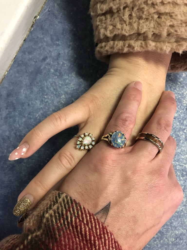 Aydian and Jenilee's 10-year wedding anniversary rings found in a vintage antique shop — hers an opal and his a black opal, since opals symbolize passion and love.