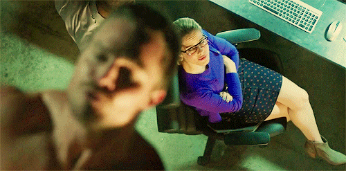 That's his tech genius partner (and potential love interest) (sorry, we won't spoil anything!), Felicity, watching him.