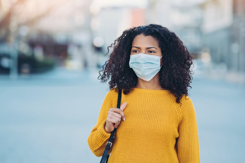 Woman wearing a face mask walking outdoors