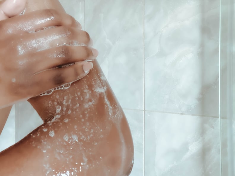 Close-up of unrecognizable woman washing upper body in shower