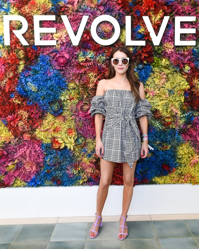 Emma Roberts wearing a gingham off-the-shoulder minidress, Salvatore Ferragamo sunglasses, and purple sandals at the Revolve Festival party. 