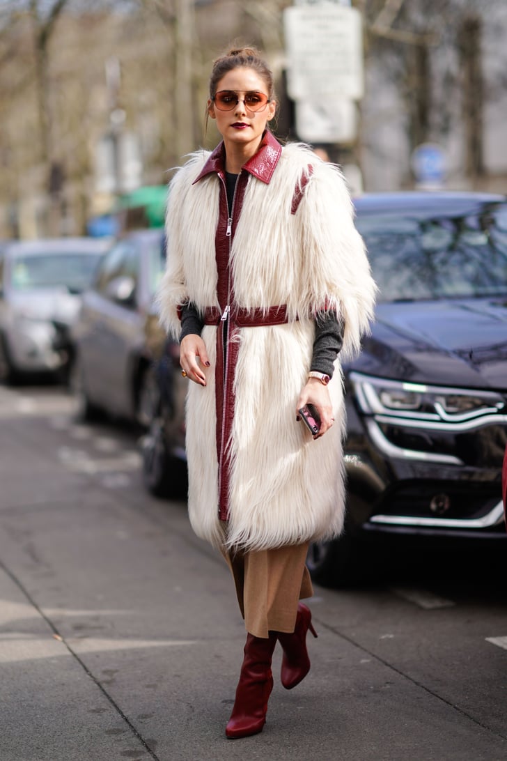 Olivia stayed warm in a white furry coat outside of the Giambattista ...