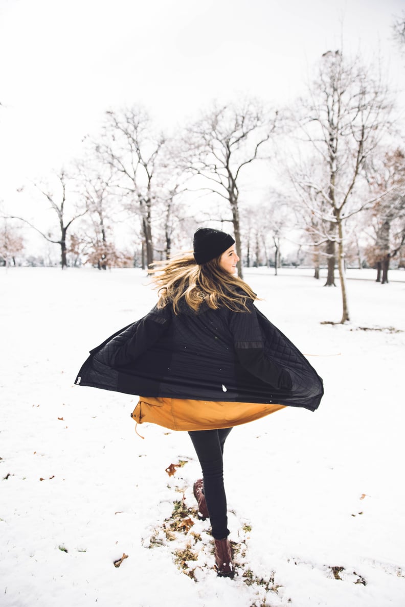woman walking in snow during december new moon in capricorn