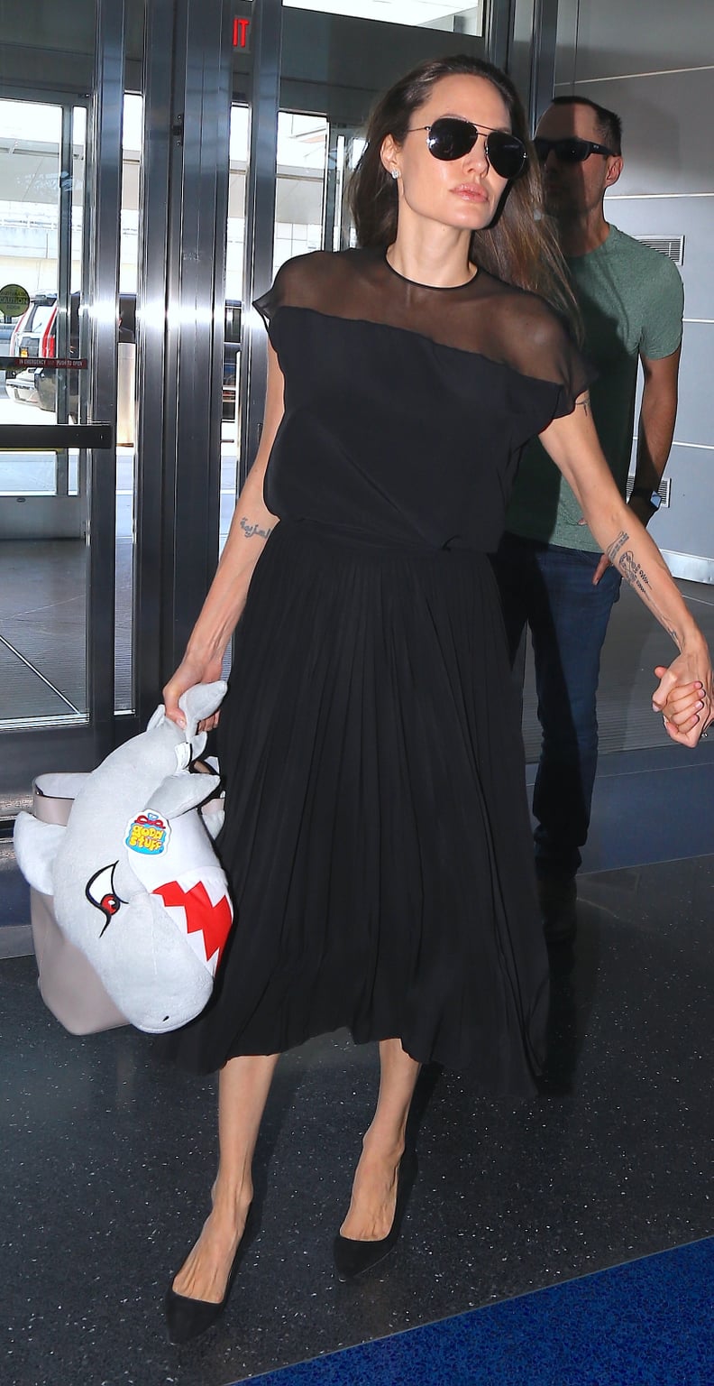 Angelina Wore a Midlength Black Dress to the Airport When Leaving NYC