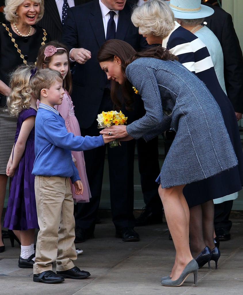 She greeted a young boy during a visit to Piccadilly Circus in March 2012.