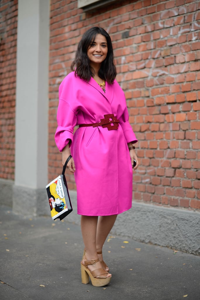 Anyone who wears a fuchsia coat is looking to spread a few smiles. A thin belt, neutral-toned platforms, and animated wrist-strap clutch took this outfit to the next level of dazzle.