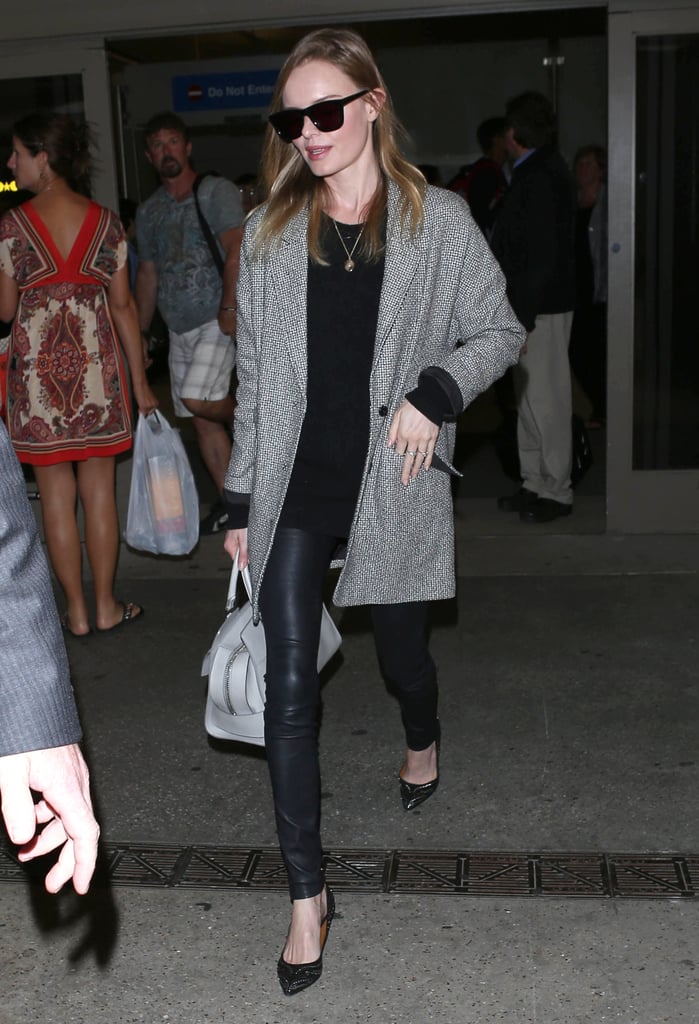 Kate layered up in an oversize tweed jacket, leather leggings, embroidered flats, and classic-cool shades after touching down at LAX in March 2013.