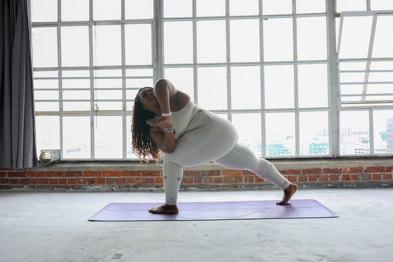 woman doing yoga vs. pilates in front of a window