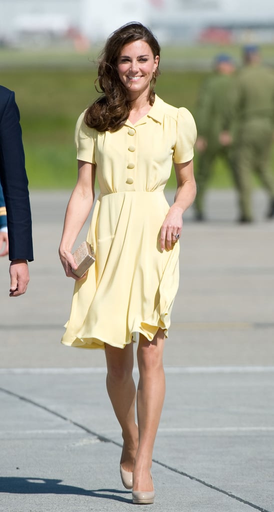 Kate's effortless plane look consisted of this bright yellow Jenny Packham number, plus a box clutch and nude pumps, both by L.K. Bennett. 
