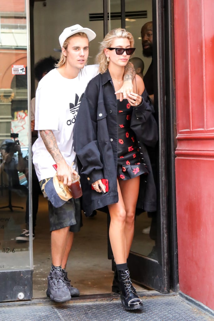 Hailey Baldwin wearing Bec & Bridge minidress with a long denim jacket and Alexander Wang boots.