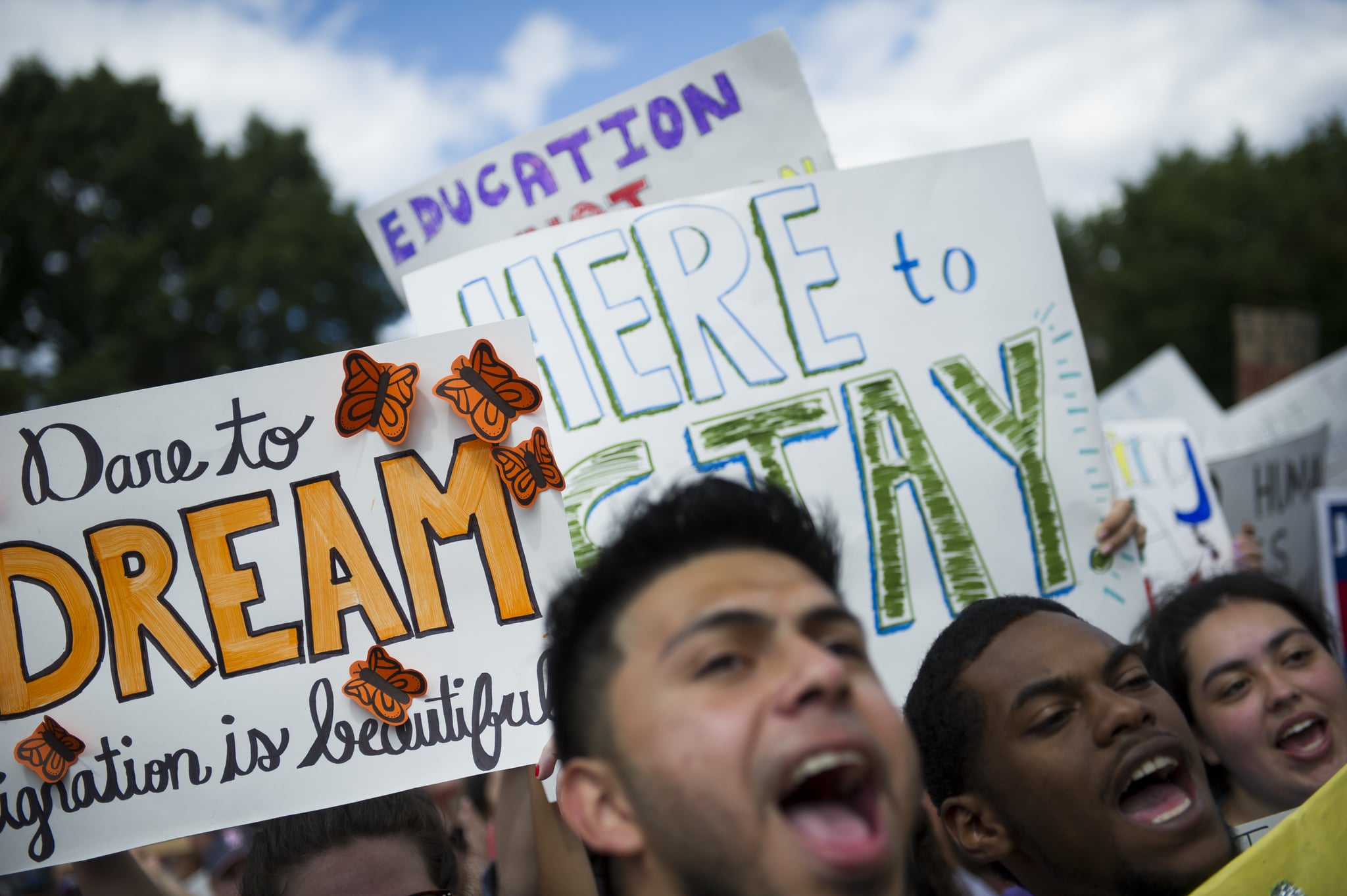 Placards and protesters seen during a DACA protest.