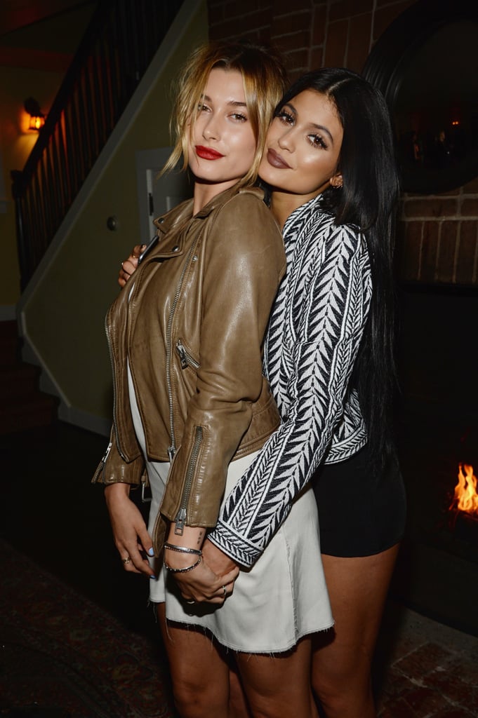 Hailey Baldwin cozied up to Kylie, showing off her white minidress and brown leather moto jacket.