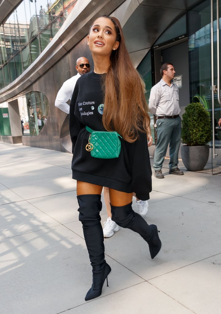 Ariana cinched her hoodie with a quilted, kelly green Chanel fanny pack for an outing in NYC in August.
