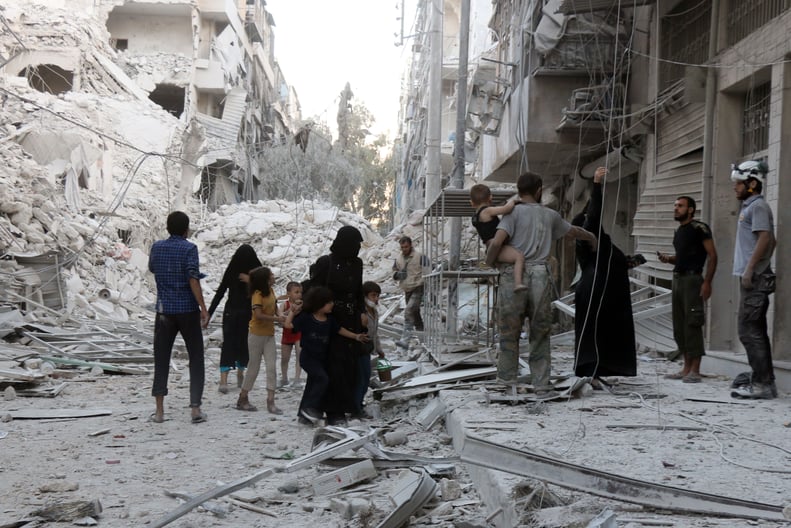 A family assesses the destruction after an airstrike in Aleppo.